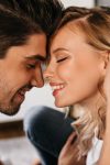 portrait two beautiful people love smiling with closed eyes tender man touching his attractive girlfriend happy blonde girl modern apartments wih her boyfriend