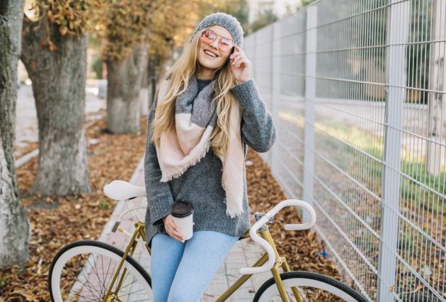 smiling woman with cup bicycle
